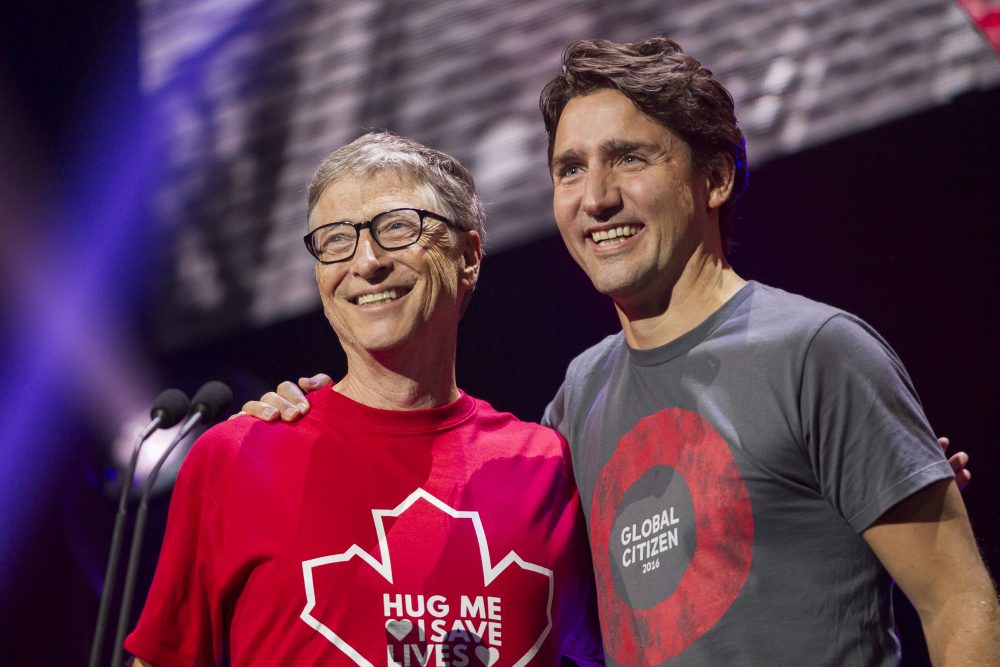 Billionaire philanthropist Bill Gates receives a hug from Canadian Prime Minister Justin Trudeau at the Global Citizen Concert to End AIDS, Tuberculosis and Malaria in Montreal, Quebec, September 17, 2016.  AFP Photo/ POOL/ Geoff Robins